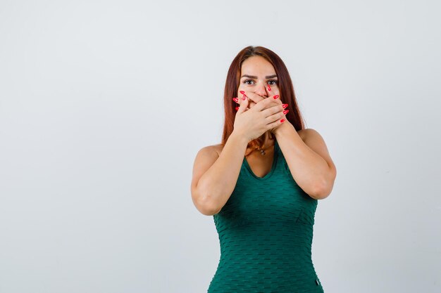 Young woman with long hair wearing a green bodycon