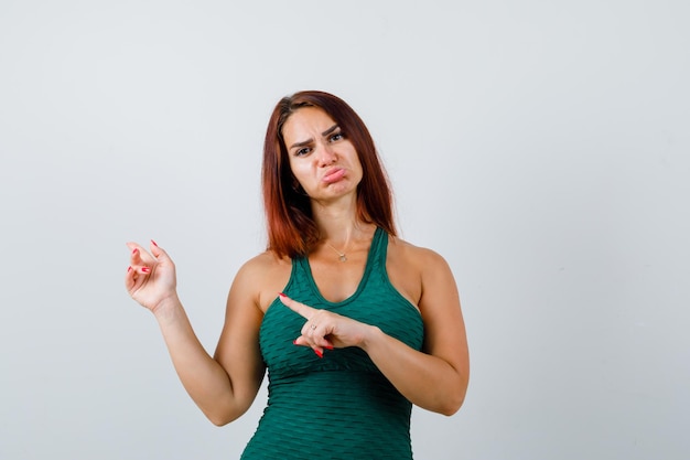 Young woman with long hair wearing a green bodycon