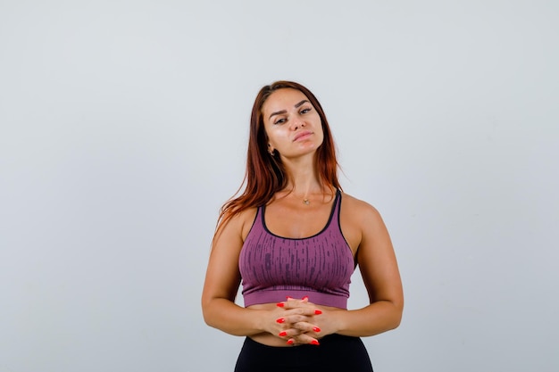 Free photo young woman with long hair wearing sportswear