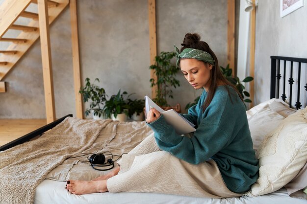 Young woman with messy bun working from home