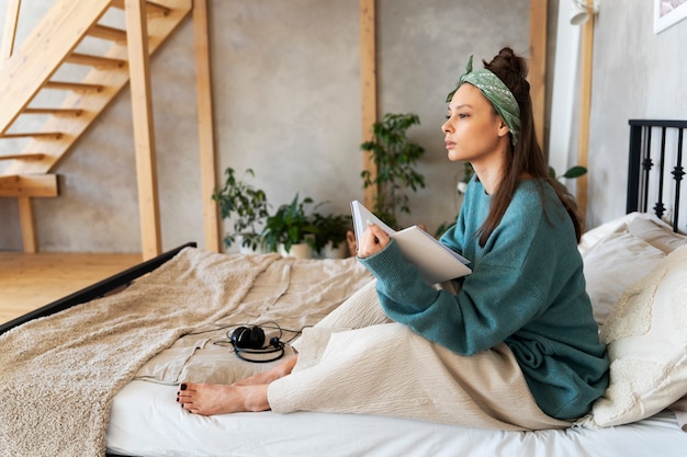 Young woman with messy bun working from home