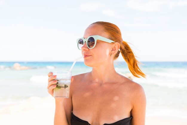 Young woman with mojito