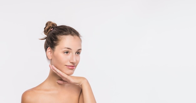 Free photo young woman with naked shoulders on white background