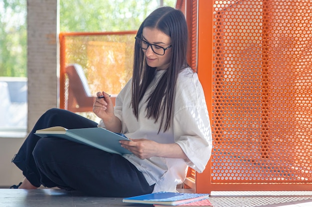 Free photo young woman with notebooks study and teaching concept