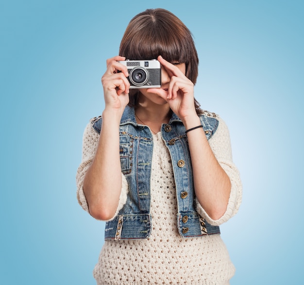 Young woman with a old camera