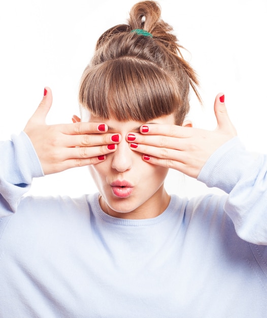 Young woman with painted nails covering her eyes