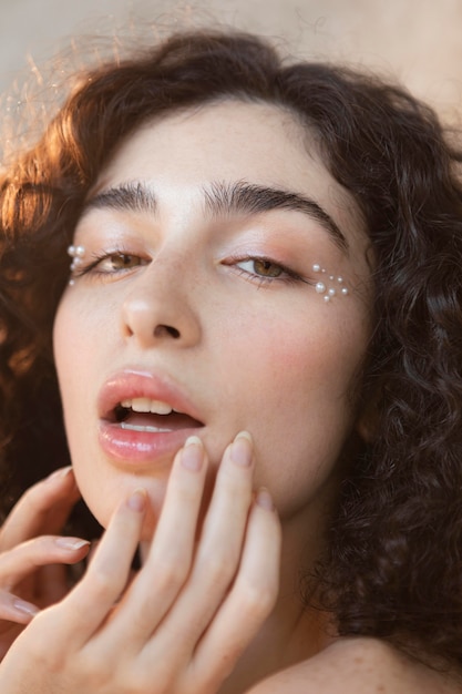 Free photo young woman with pearls make up