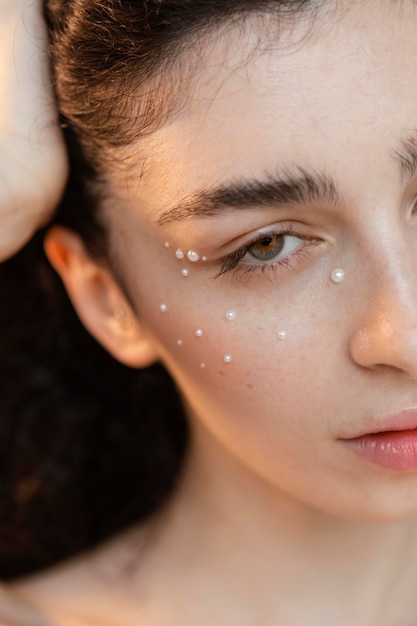 Free photo young woman with pearls make up