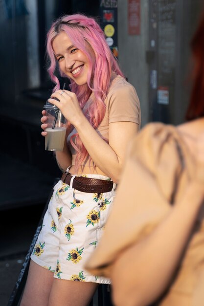 Young woman with pink hair smiling