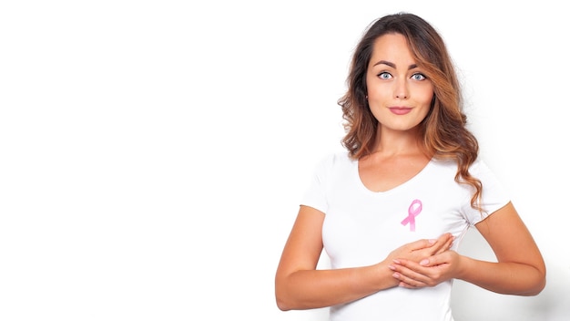 Young woman with a pink ribbon supporting breast cancer awareness