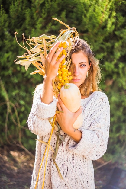 Young woman with sandthorn berries and marrow