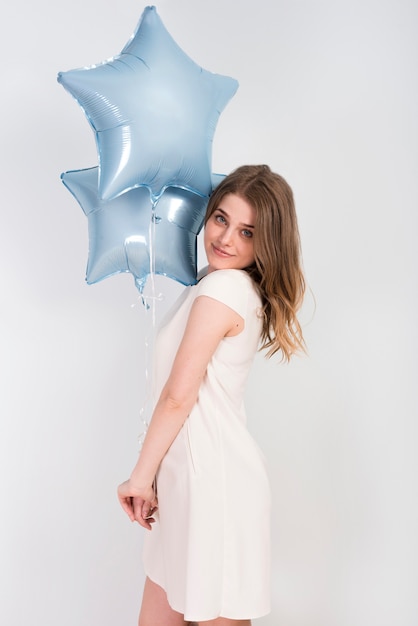 Free photo young woman with shiny party balloons