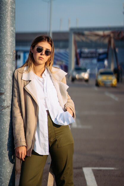 Young woman with shopping bags on a bus stop