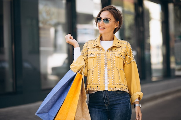 Young woman with shopping bags in the city