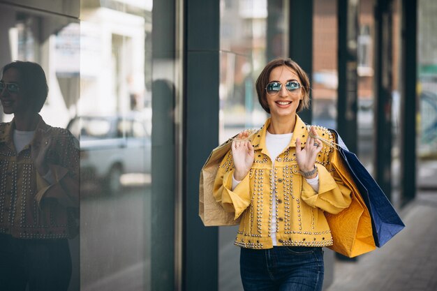 Young woman with shopping bags in the city