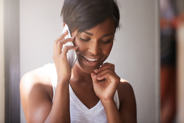 Young woman with short hair talking on the phone