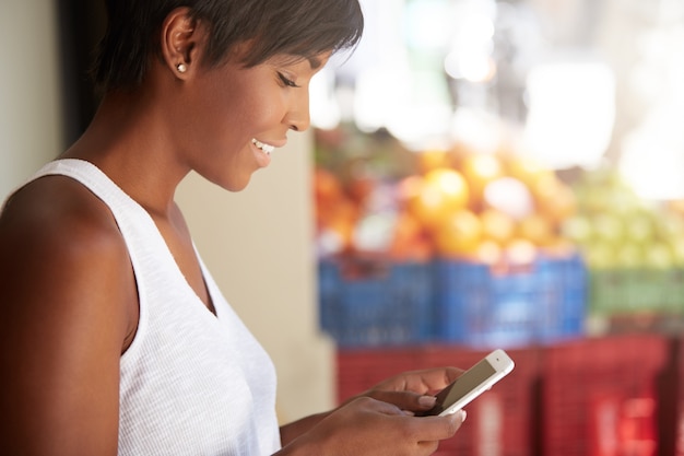 Young woman with short hair using phone