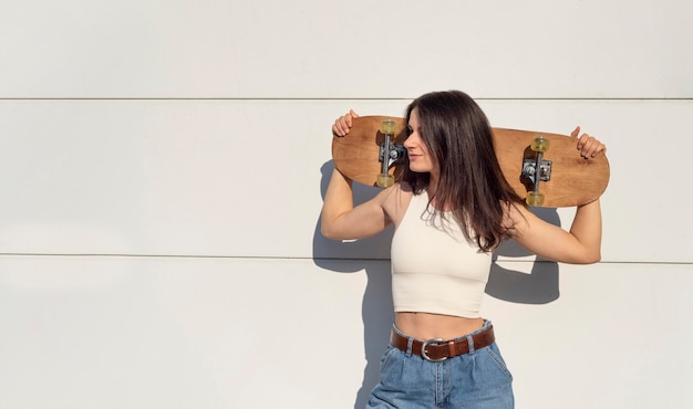 Free photo young woman with skateboard