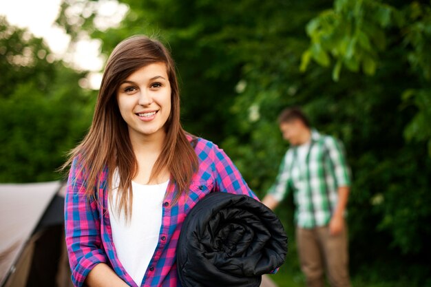 Young woman with sleeping bag