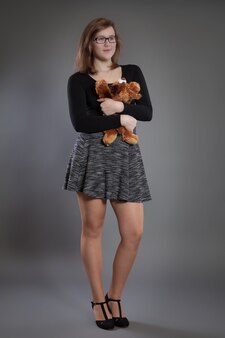 Young woman with a soft toy