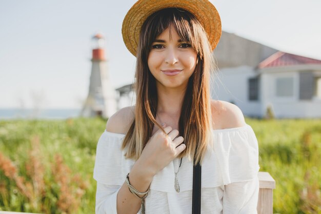 Young woman with straw hat in the countryside