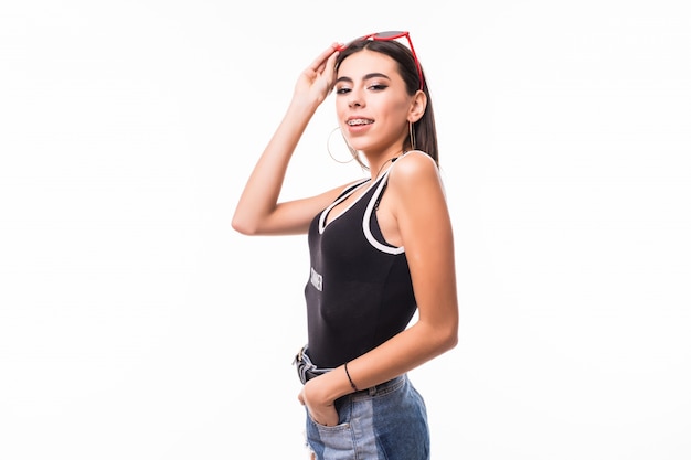 Young woman with sunglasses on head dressed in short jeans