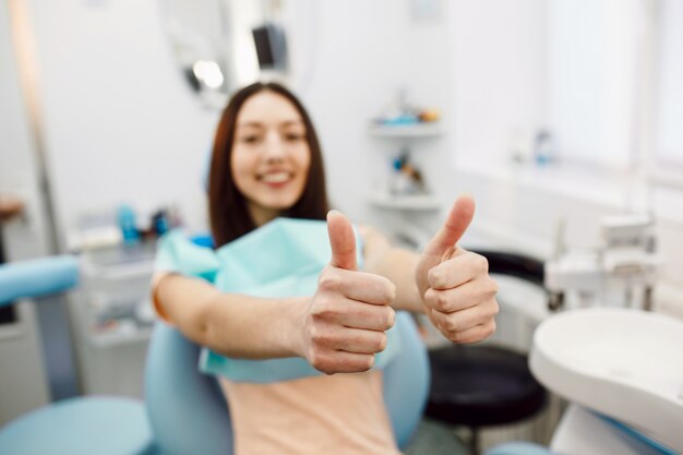 Young woman with thumbs up at the clinic