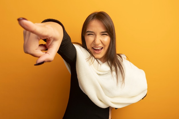 Free photo young woman with white scarf happy and cheerful pointing with index figner at something smiling