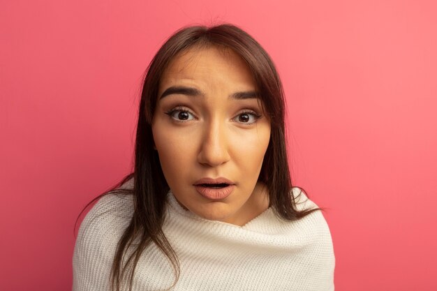 Young woman with white scarf surprised 