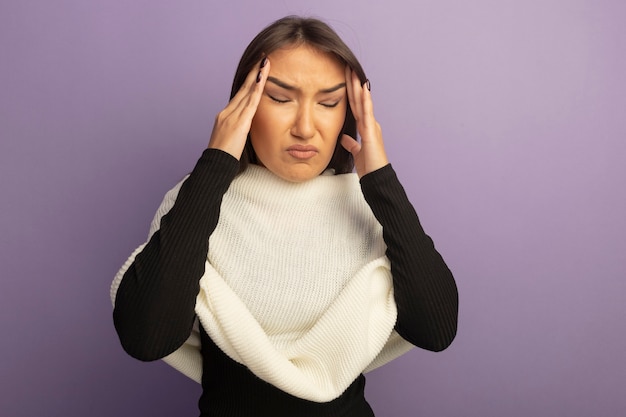 Free photo young woman with white scarf touching her temples looking unwell having headache