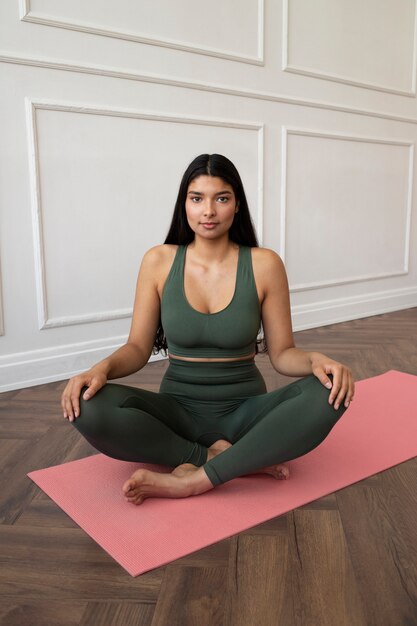 Young woman with yoga essentials