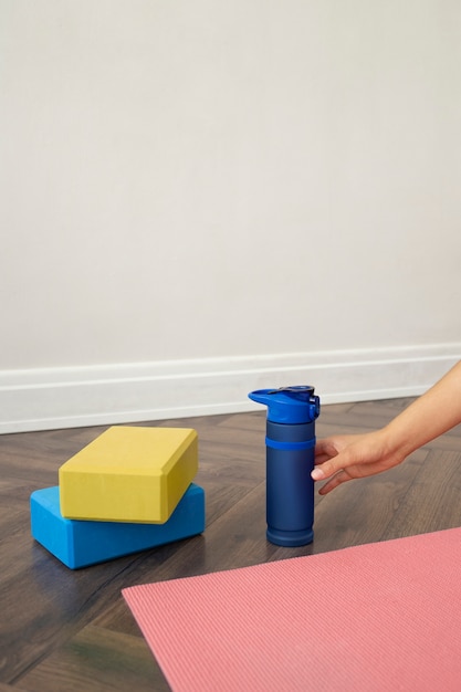 Free photo young woman with yoga essentials