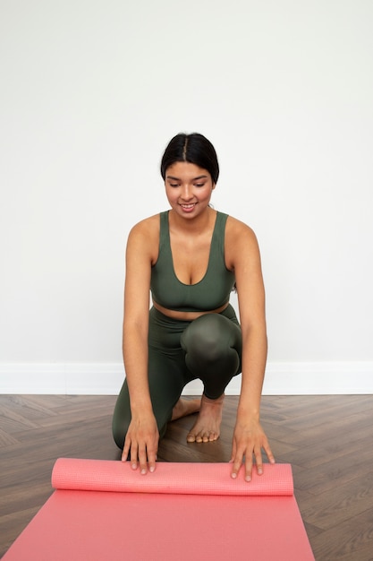 Young woman with yoga essentials