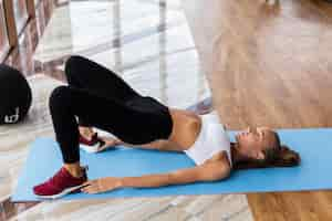 Free photo young woman working active while training at gym