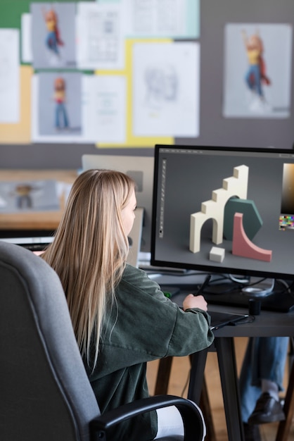 Free photo young woman working in an animation studio