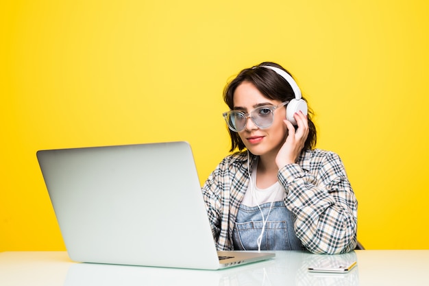 Young Woman working on desk with laptop isolated