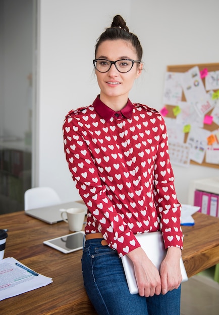 Young woman working on digital tablet at office