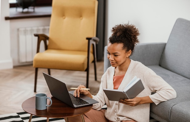 Free photo young woman working from home