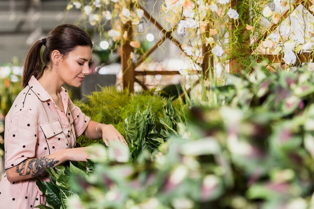 Young woman working in green house 