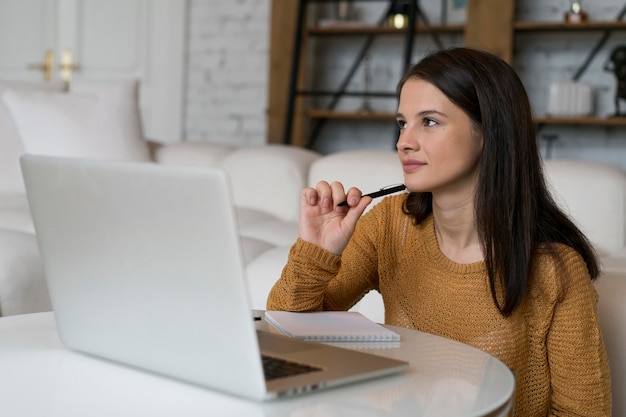 Free photo young woman working on her laptop