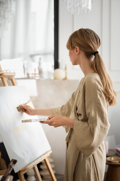 Free photo young woman working in her worshop