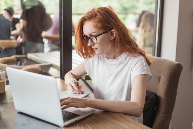 Young woman working on laptop at table