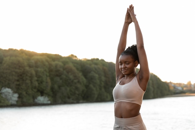 Free photo young woman working out alone outdoors