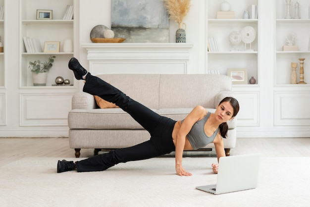 Free photo young woman working out at home