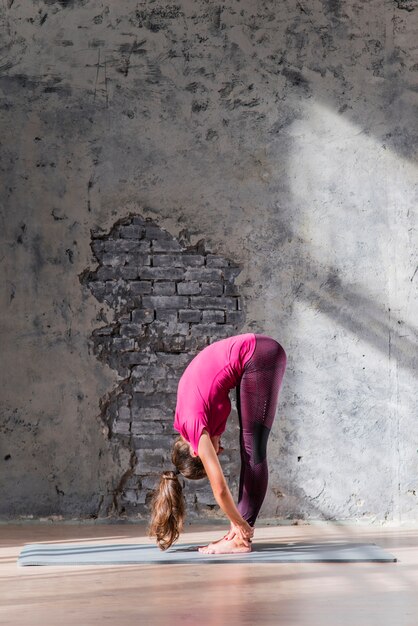 Young woman working out in loft interior