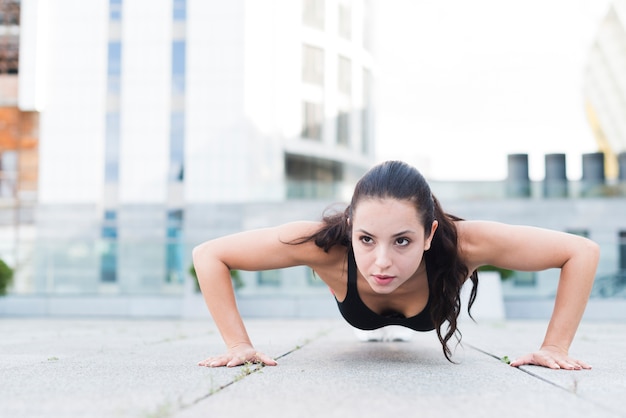 Free photo young woman working out at the street