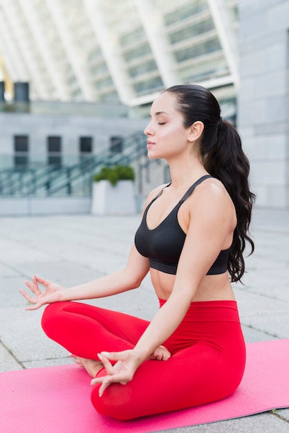 Young woman working out at the street