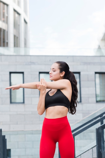 Young woman working out at the street