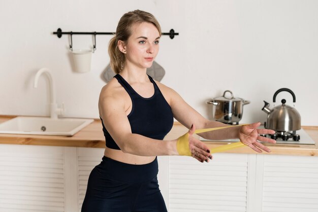 Young woman working out with elastic bands