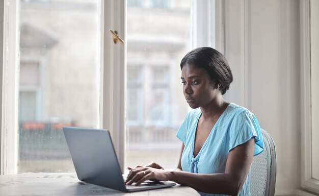 young woman works with computer at home